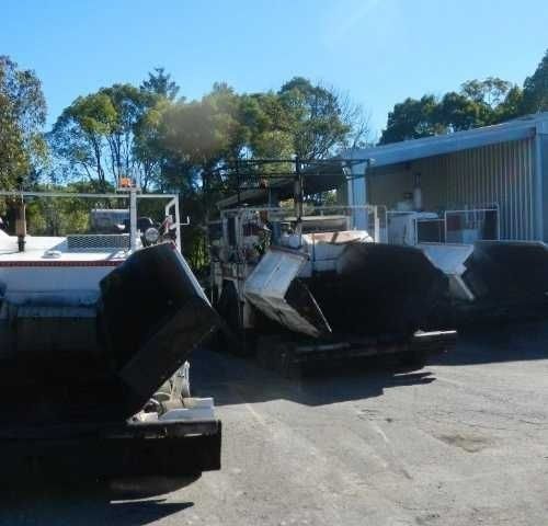 A Row of machines Are Parked in A Parking Lot — Roll Formed Driveways in Yandina, QLD