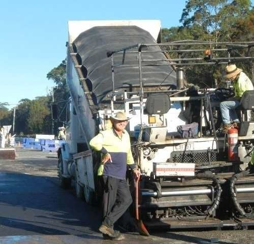A Man Standing Next to A Truck — Roll Formed Driveways in Yandina, QLD