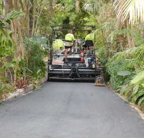 A Group of People Are Working on A Road — Roll Formed Driveways in Yandina, QLD