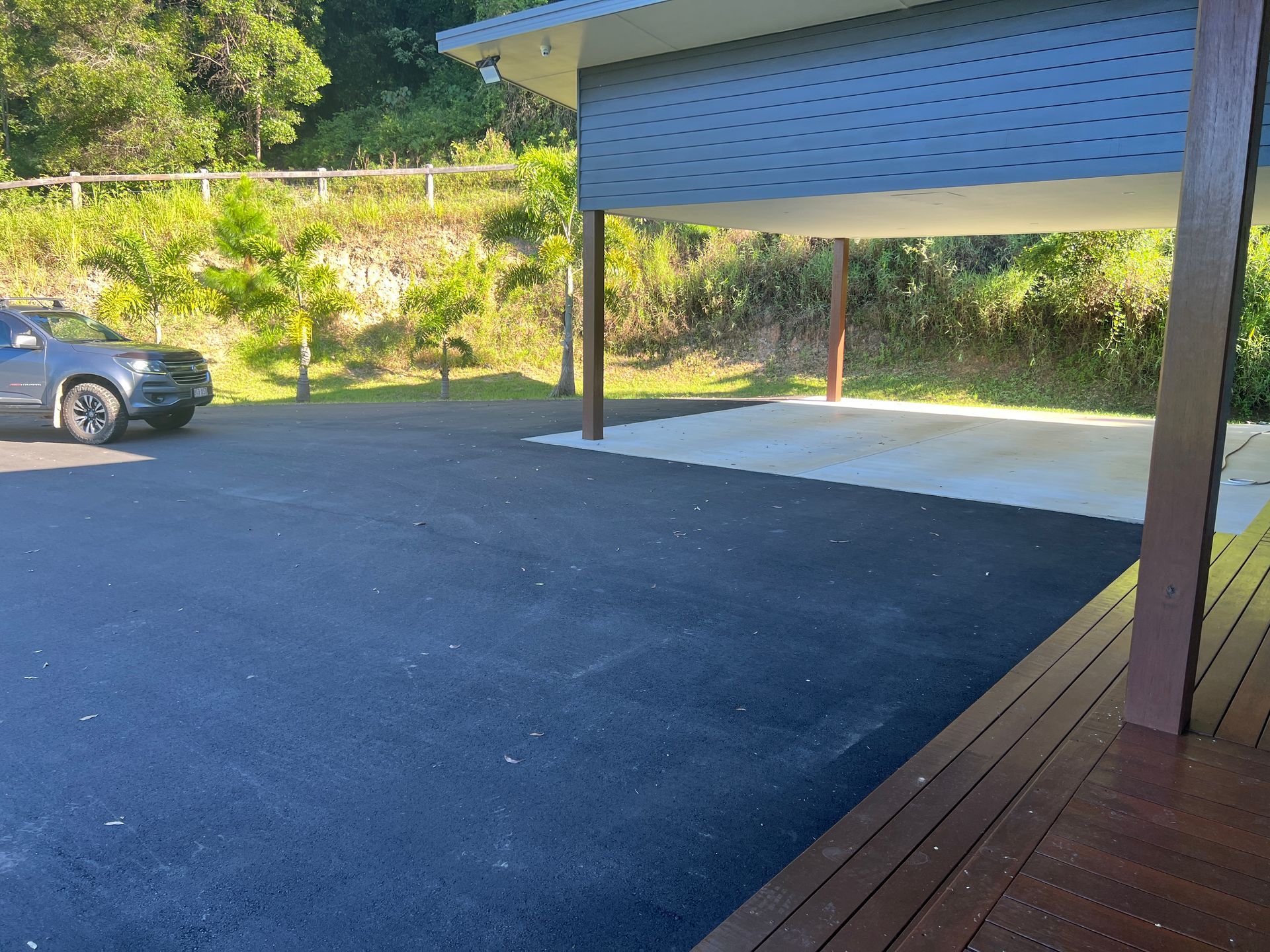 A Parking lot with a Sidewalk and Trees in the Background — Roll Formed Driveways in Yandina, QLD