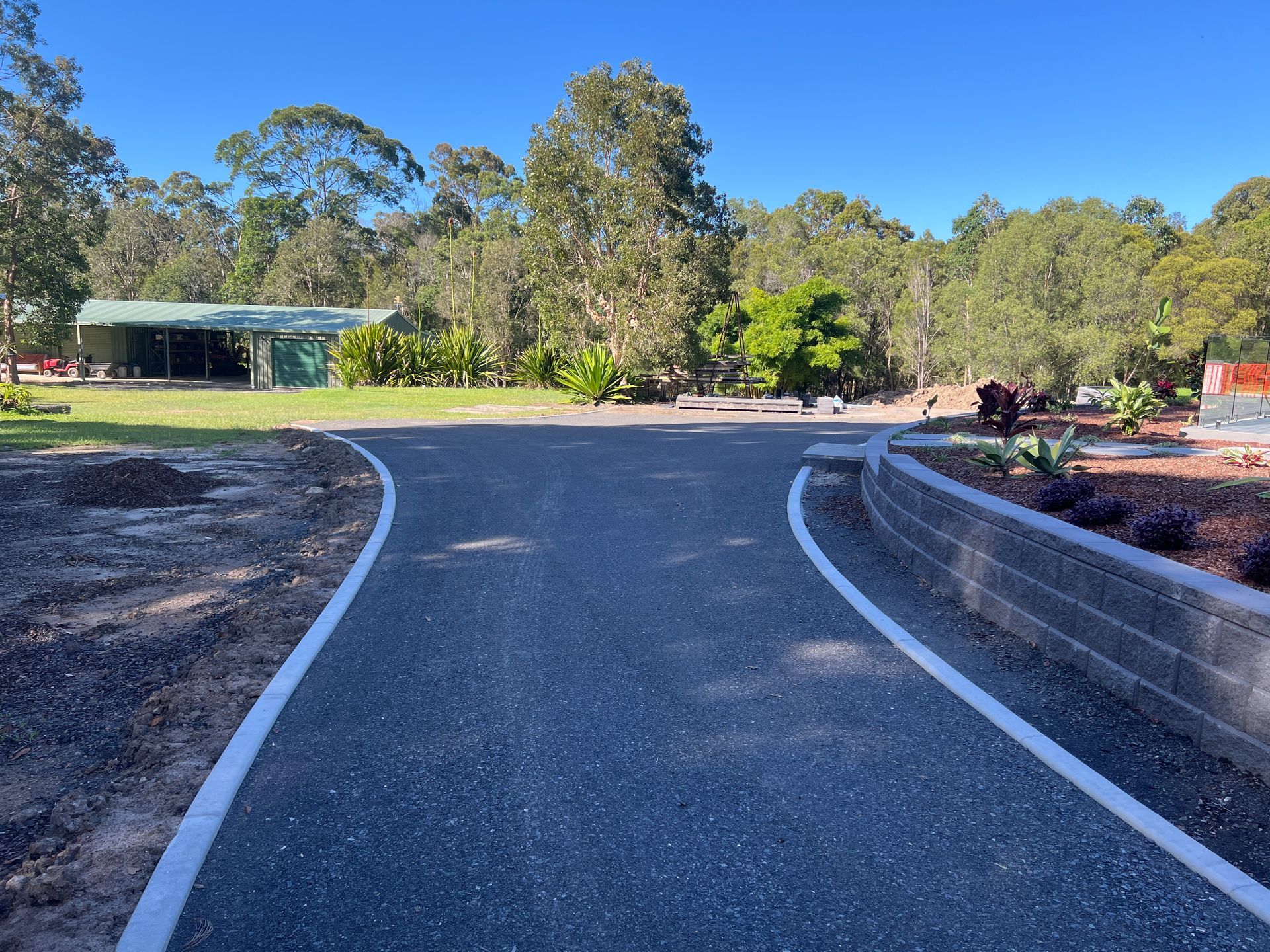 A road with a white line on the side of it — Roll Formed Driveways in Yandina, QLD