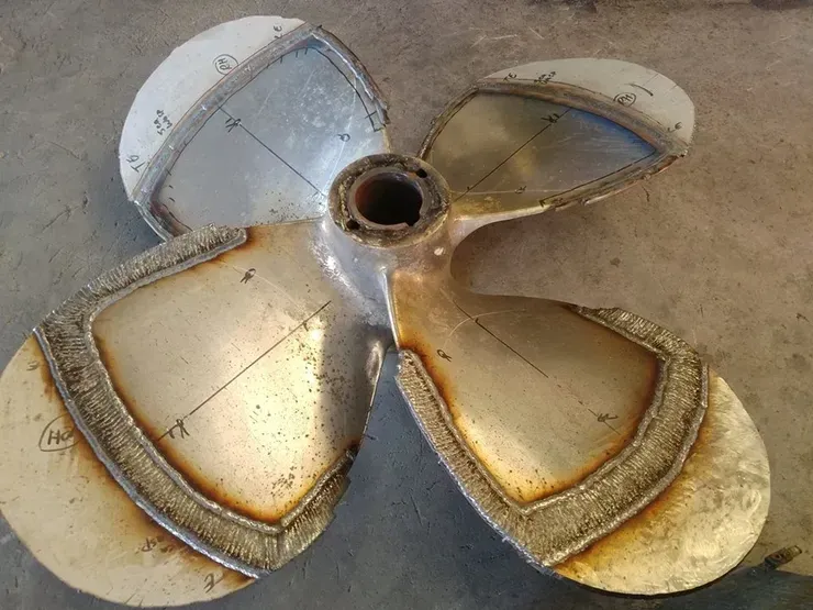 A close up of a metal propeller on a table