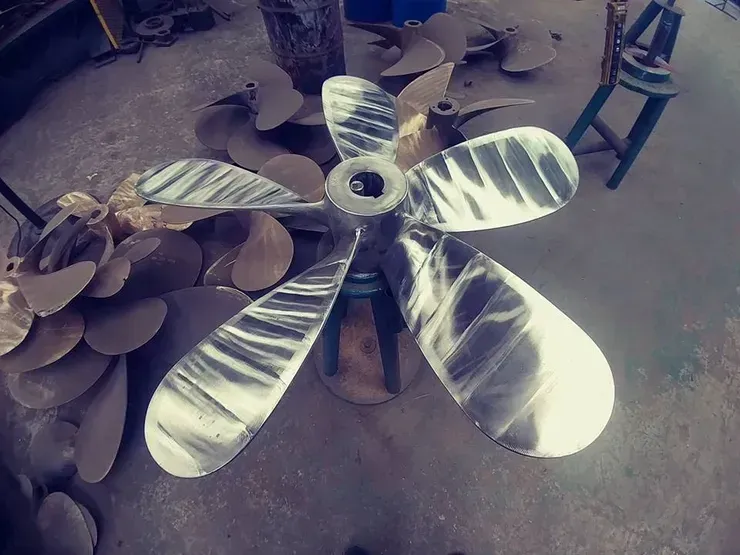 A large metal propeller is sitting on a stool