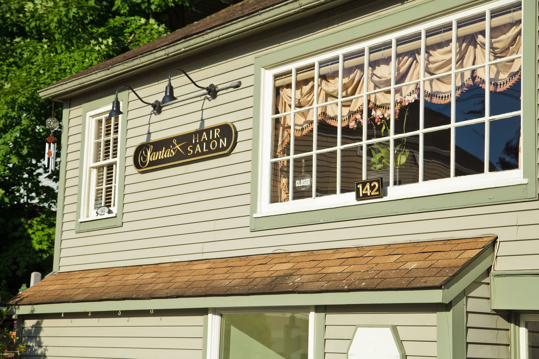 A building with a lot of windows and a sign that says hair salon