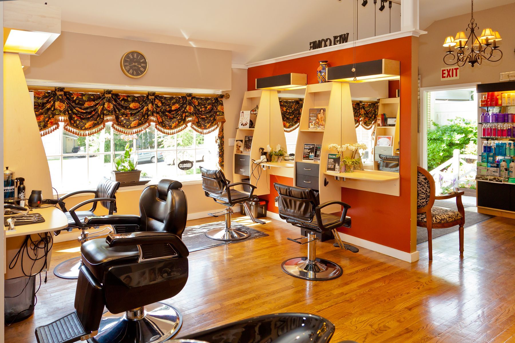 A salon with a lot of chairs and a sign that says exit