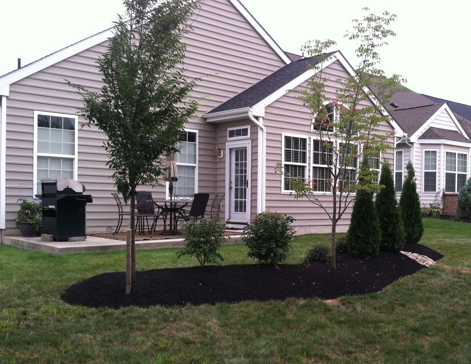 A house with a patio and trees in front of it