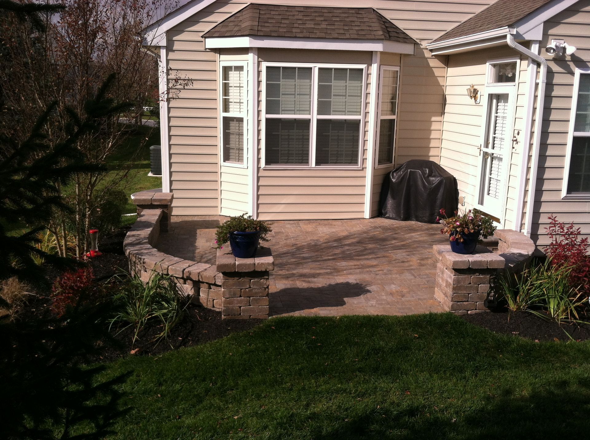 A small house with a patio in front of it