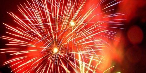 A close up of a fireworks display in the night sky