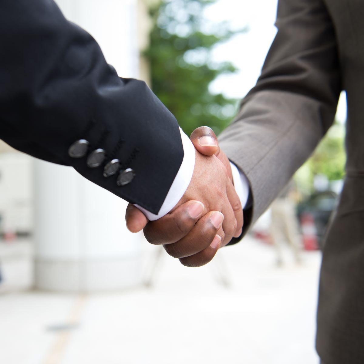 A man in a suit shakes hands with another man