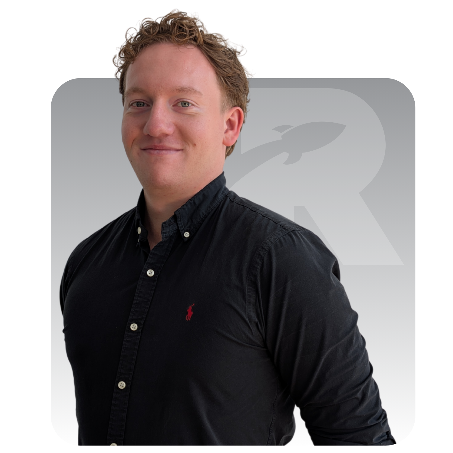 Man in a black shirt standing against a white background with a faint logo and vertical text.