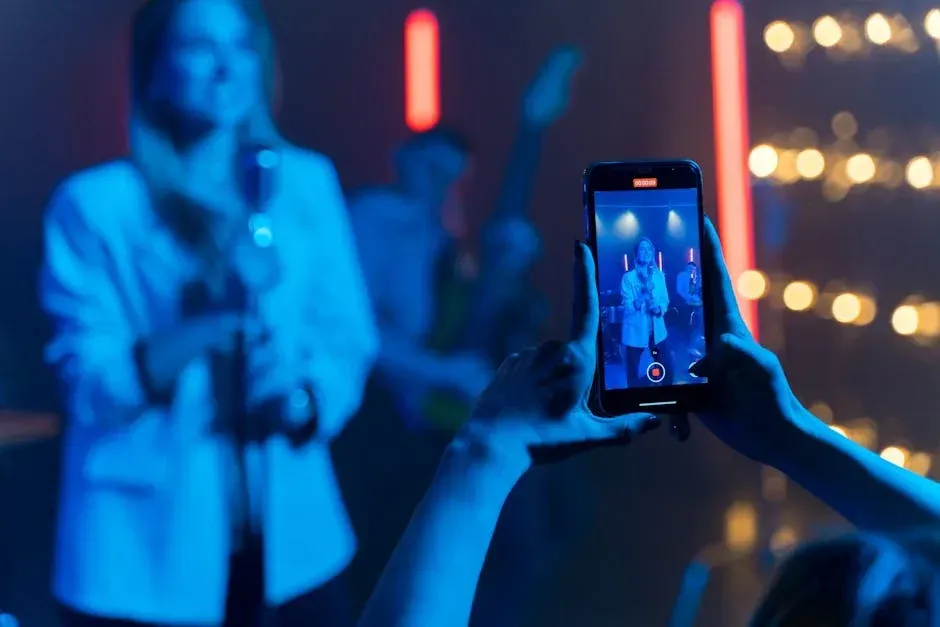 A person is taking a picture of a woman singing into a microphone.