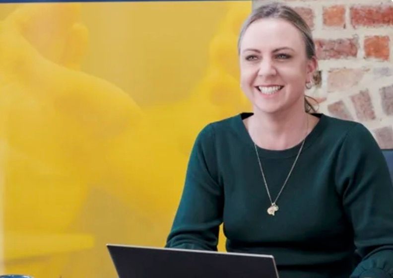 Smiling RankingCo strategist on a call with a client