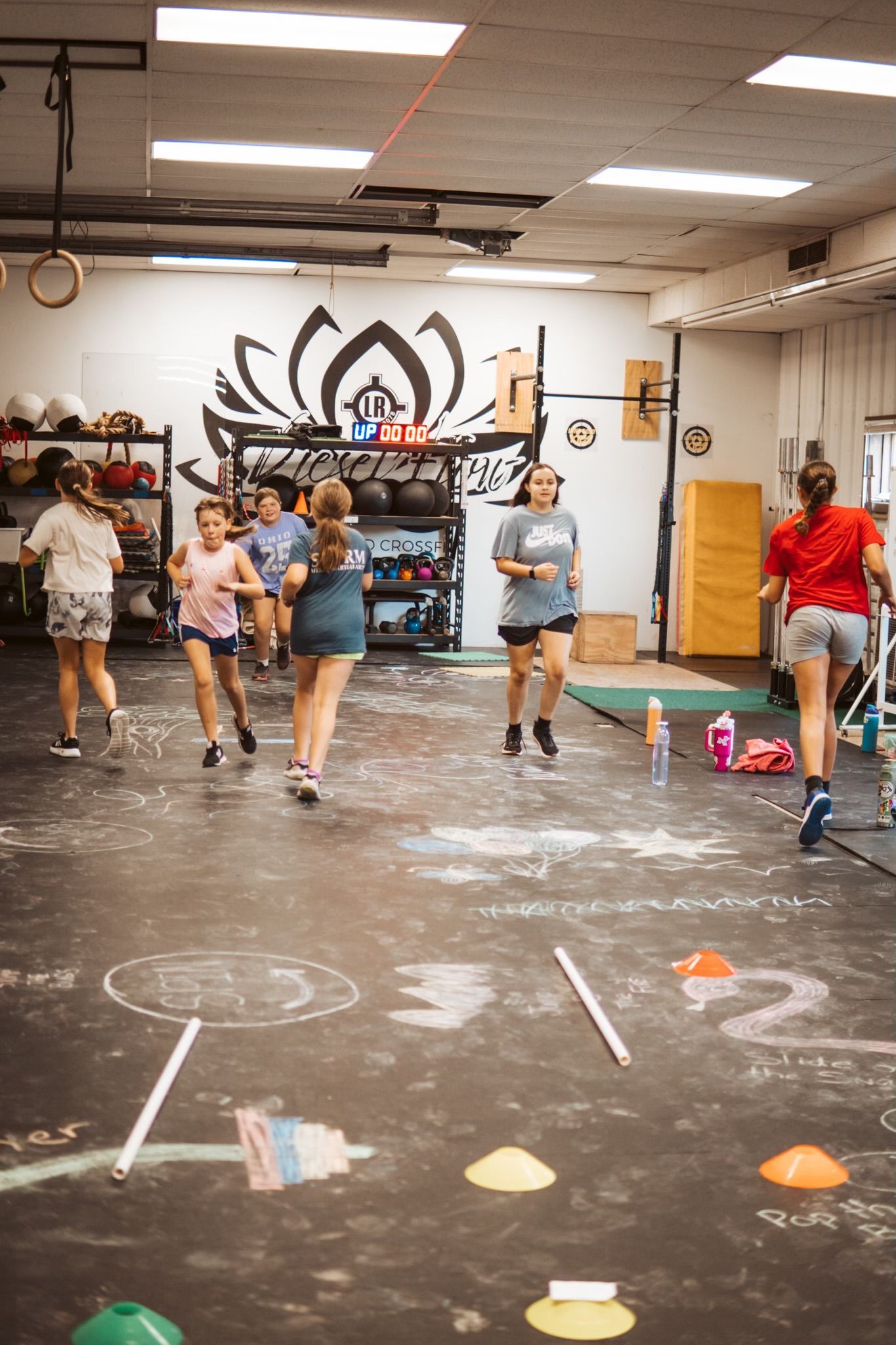 People spaced apart in a dance studio in Springfield, OH, following an instructor with cones and floor markings.