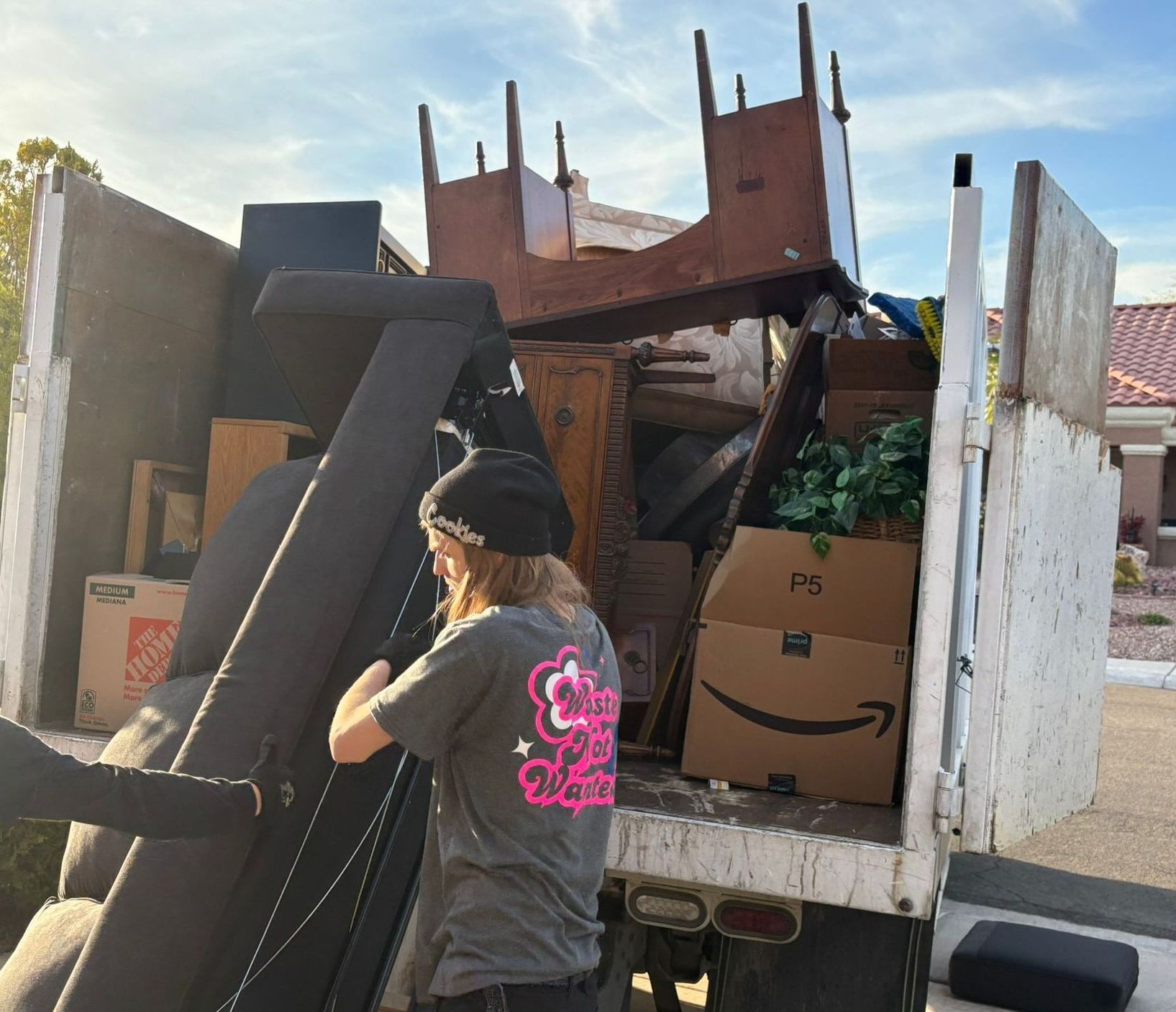 Full House cleanouts. Man Filling up a truck with items for donation.