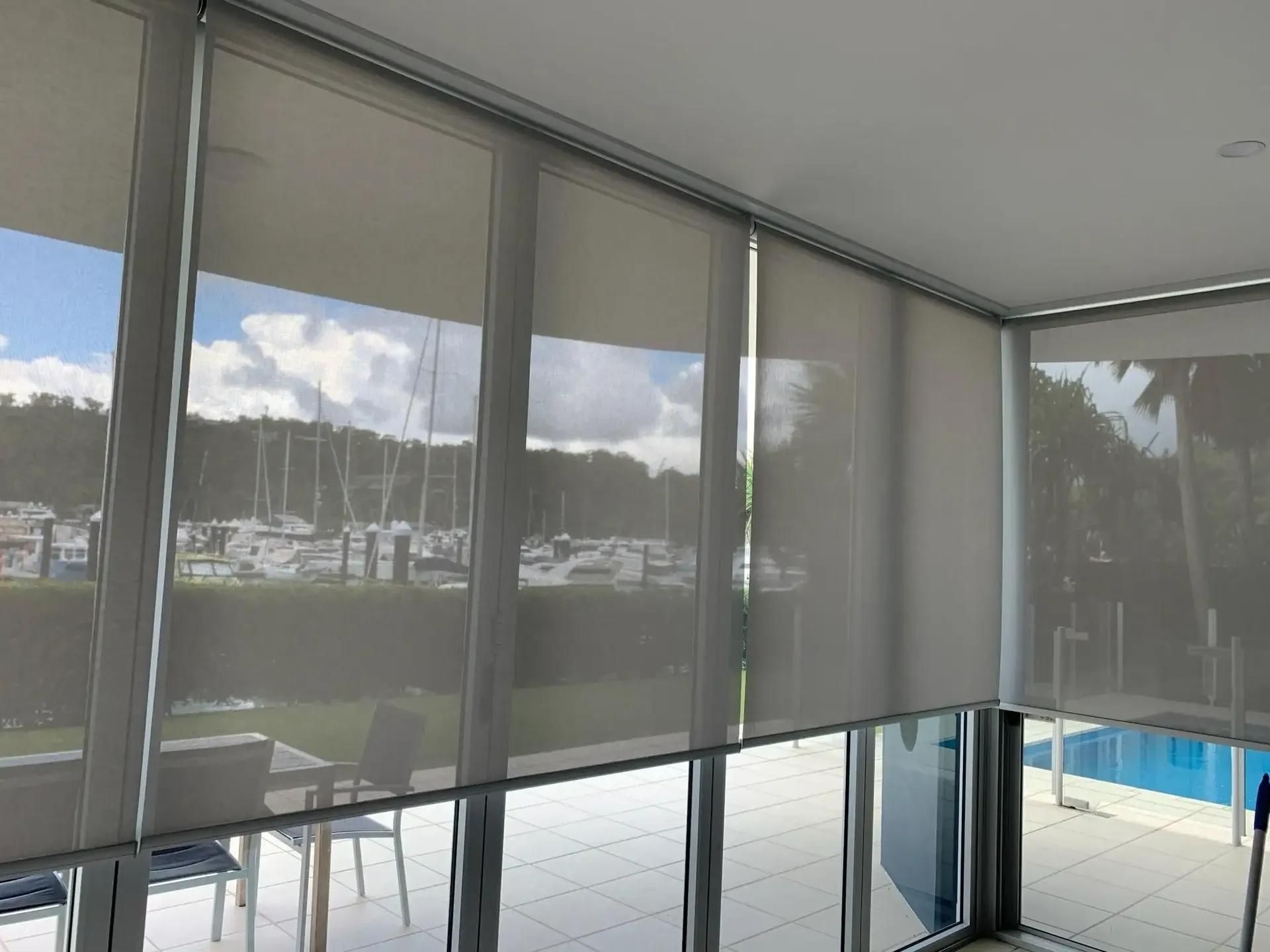A Room With a Lot of Windows and a Pool in the Background — Mi-ekka Designs in Cannonvale, QLD
