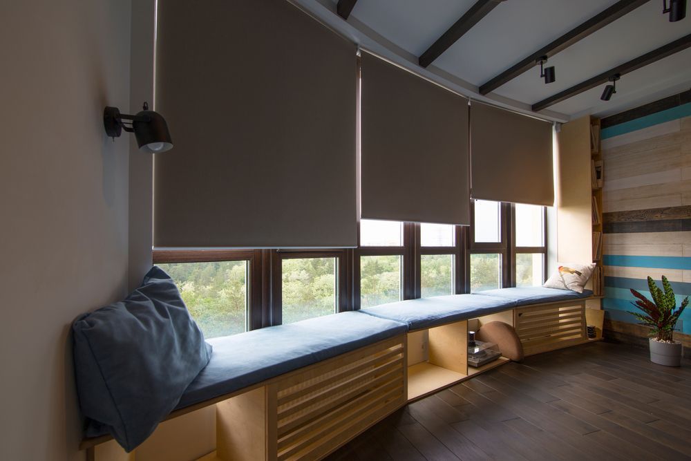 A Living room with a Coffee Table, Chair, Television and Sliding glass Doors — Mi-ekka Designs in Cannonvale, QLD