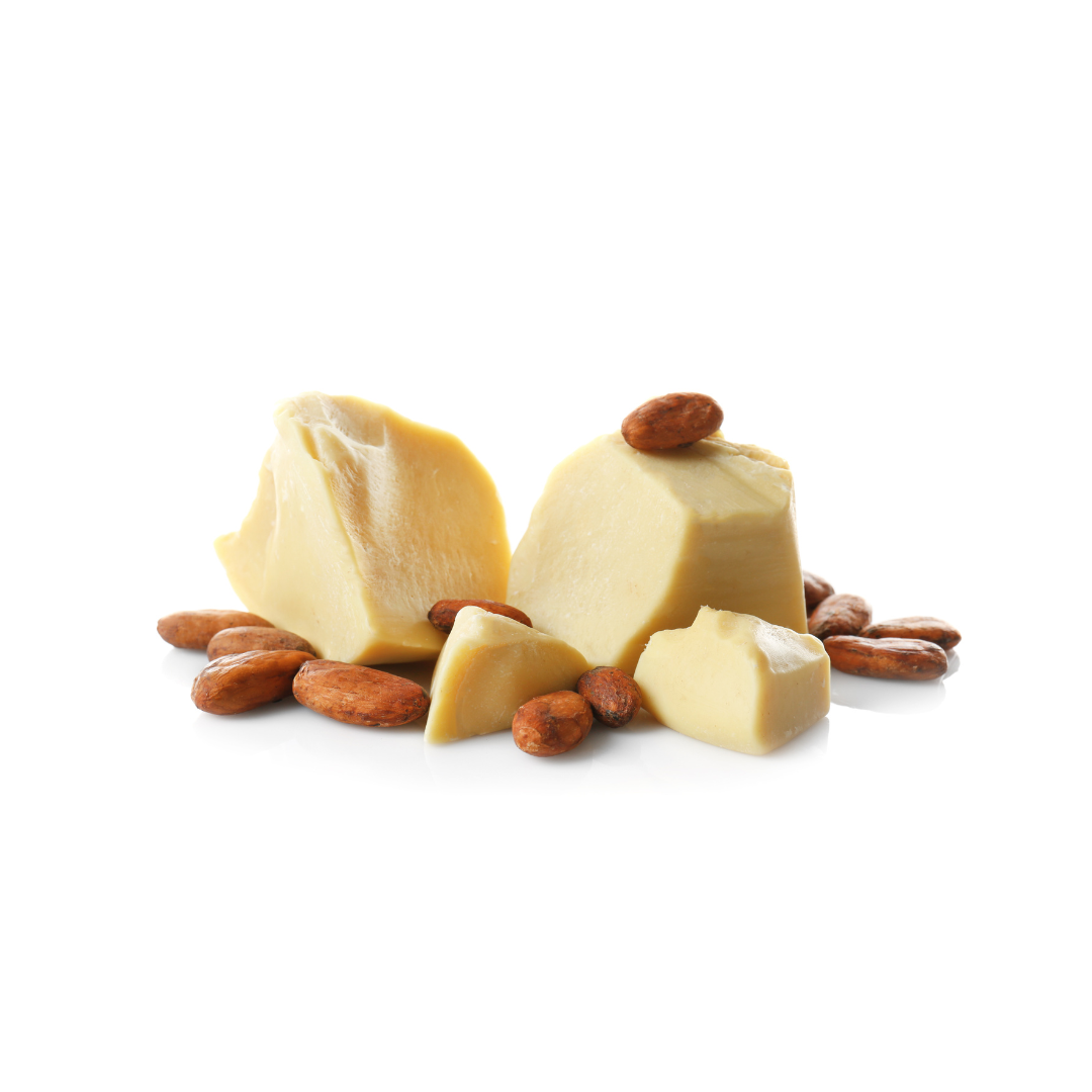 Pezzi di burro di cacao giallo pallido circondati da semi di cacao marrone scuro sparsi su sfondo bianco.