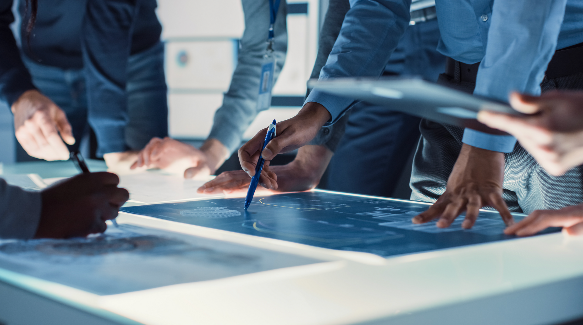 A group of people are sitting around a table looking at a map.