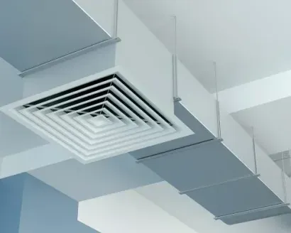 White square HVAC air diffuser mounted on a ceiling duct system against a clean, white background.