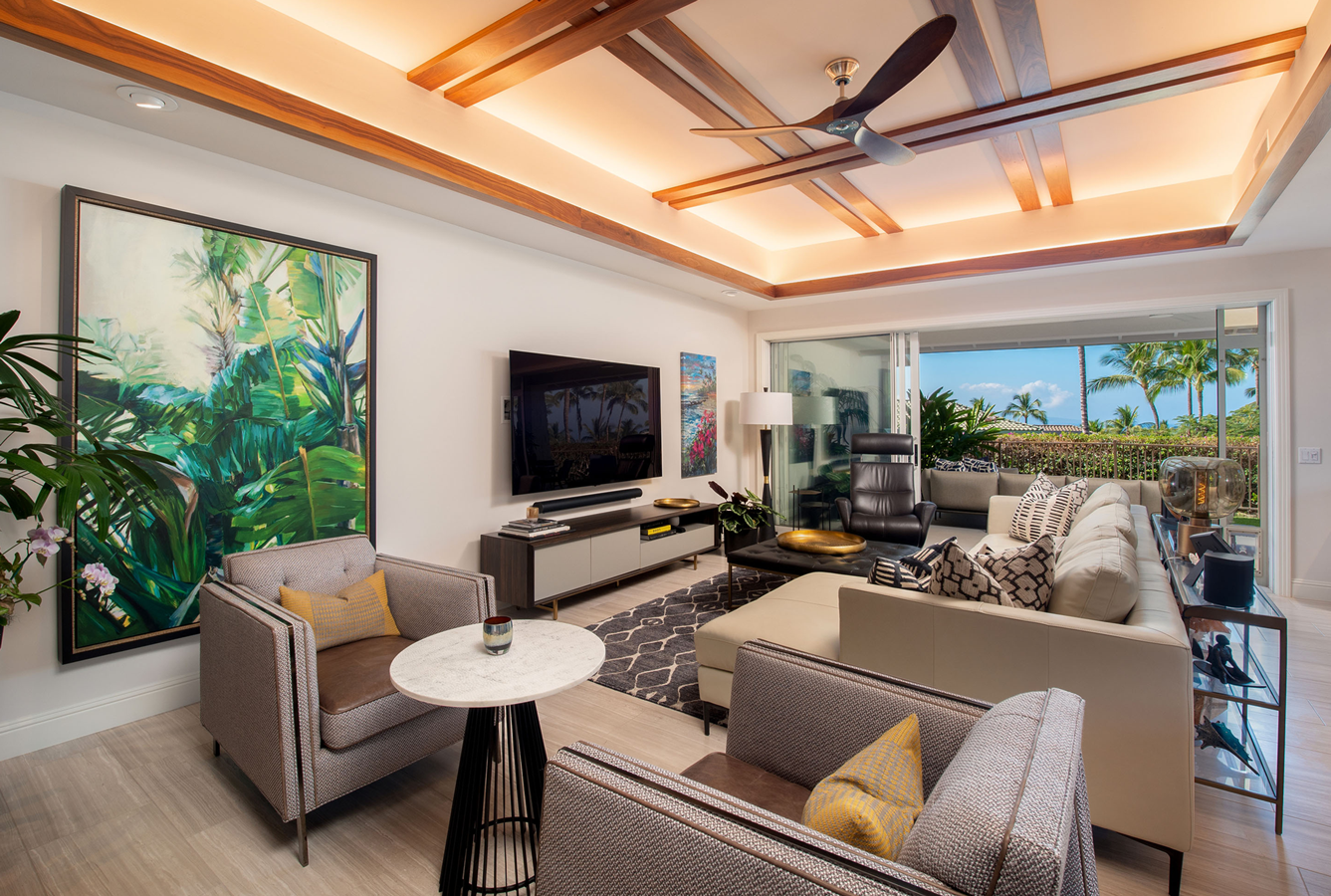 A living room with a couch , chairs , a table and a flat screen tv.