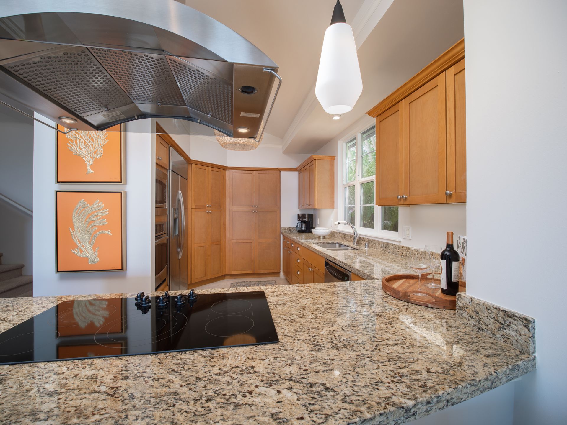 A kitchen with granite counter tops and stainless steel appliances