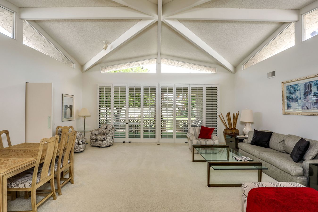 A living room with a couch , table and chairs