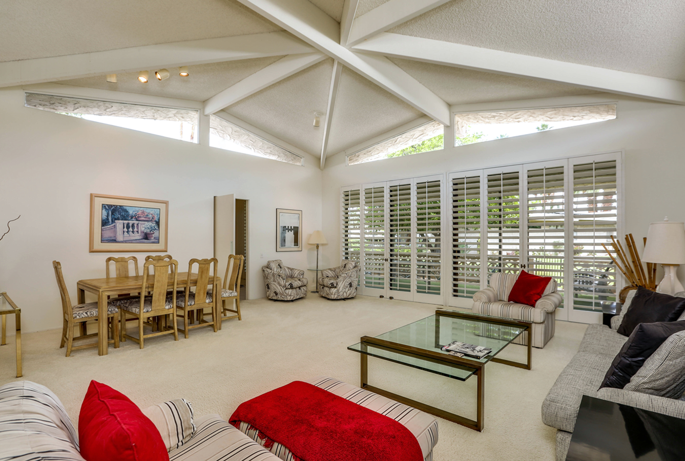 A living room with a couch a table and chairs