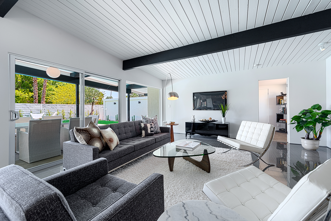 A living room with a couch , chairs , and a coffee table.