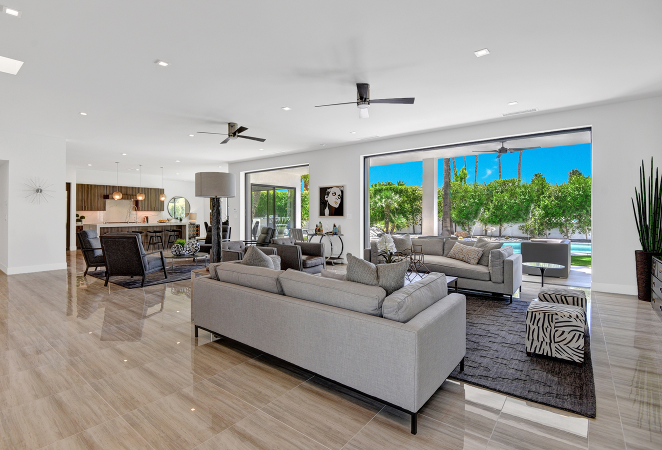 A living room filled with furniture and a ceiling fan.