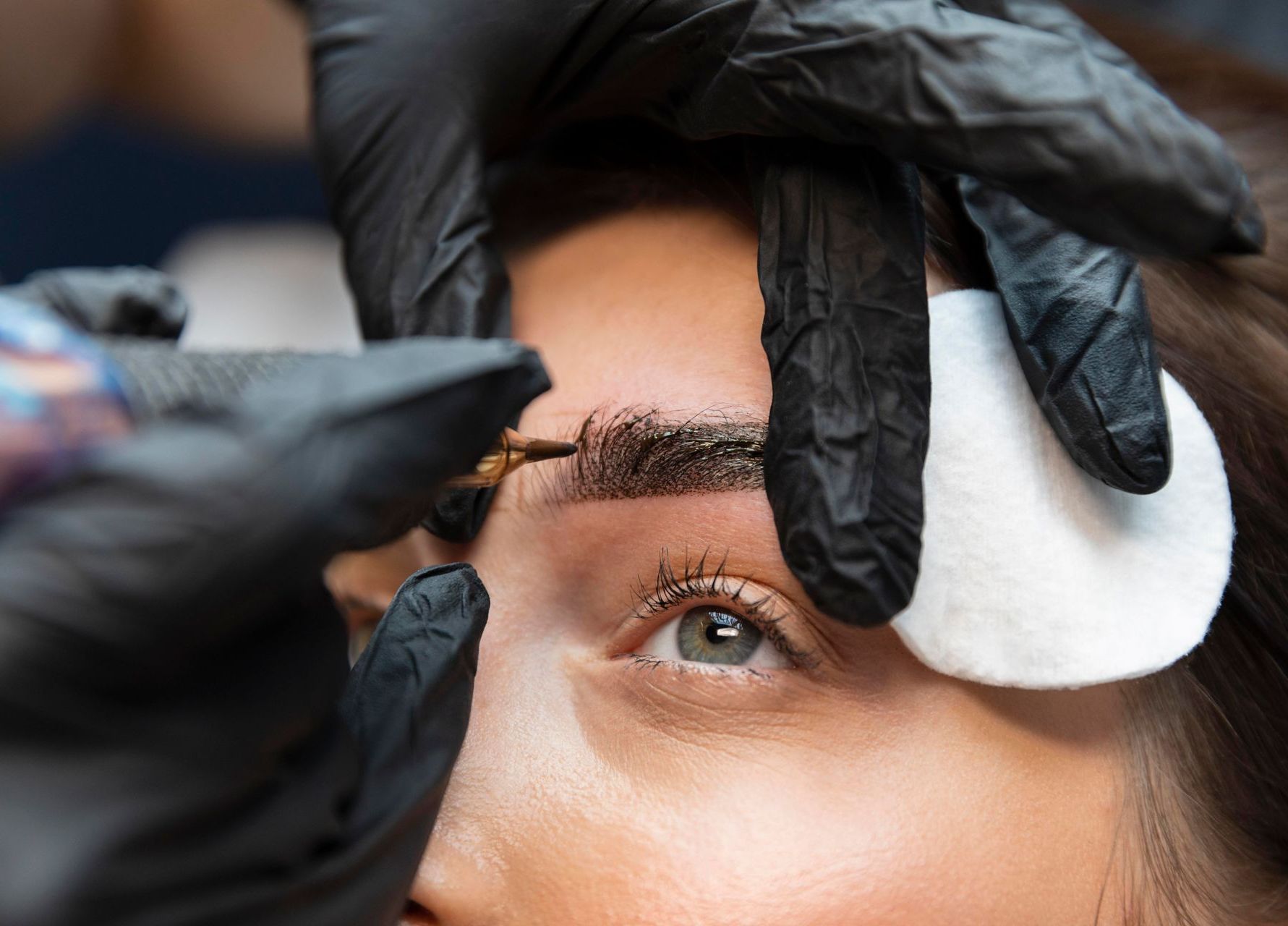 young woman getting beauty treatment her eyebrows