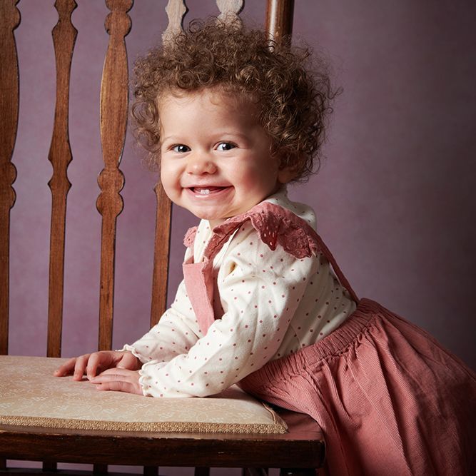 Smiling toddler girl at her Watch Me Grow final session — professional baby portrait photography, Oakley Studios, Bedfordshire