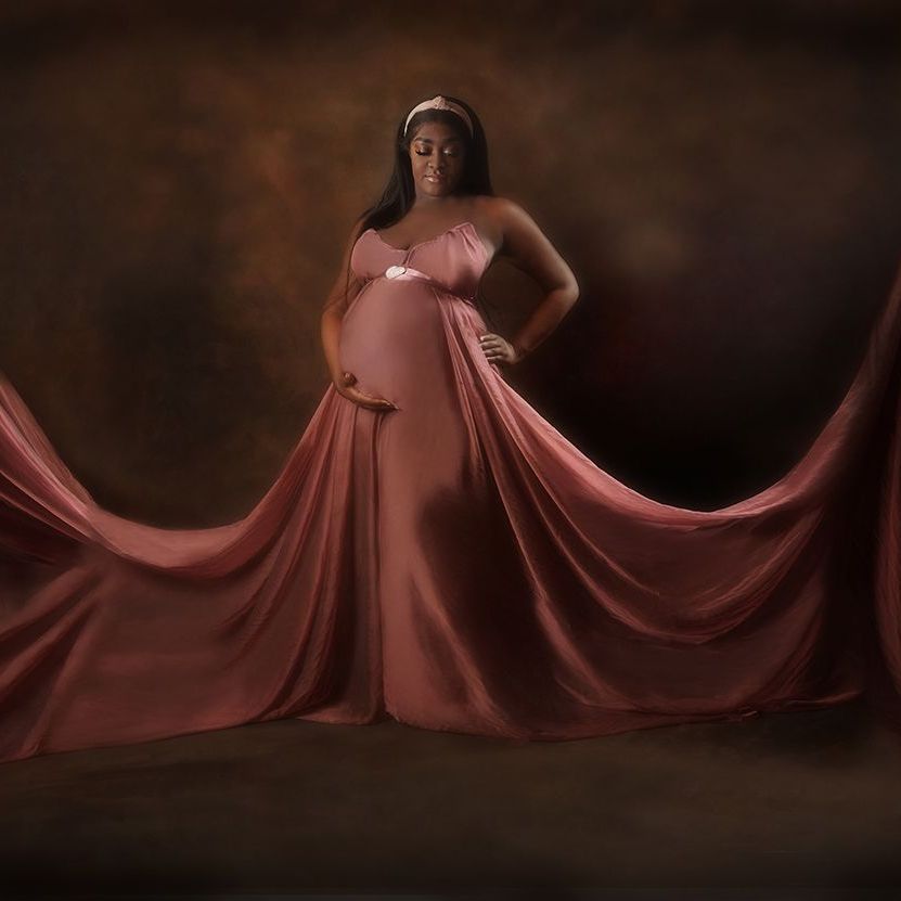 Lady in Maternity outfit on dark background
