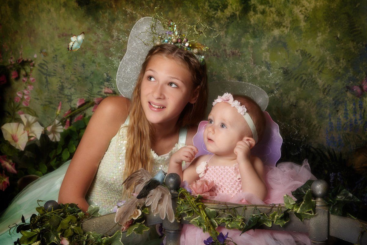 Young girl and baby sister both dressed as fairies during The Original Fairy Experience at Oakley Studios, Luton