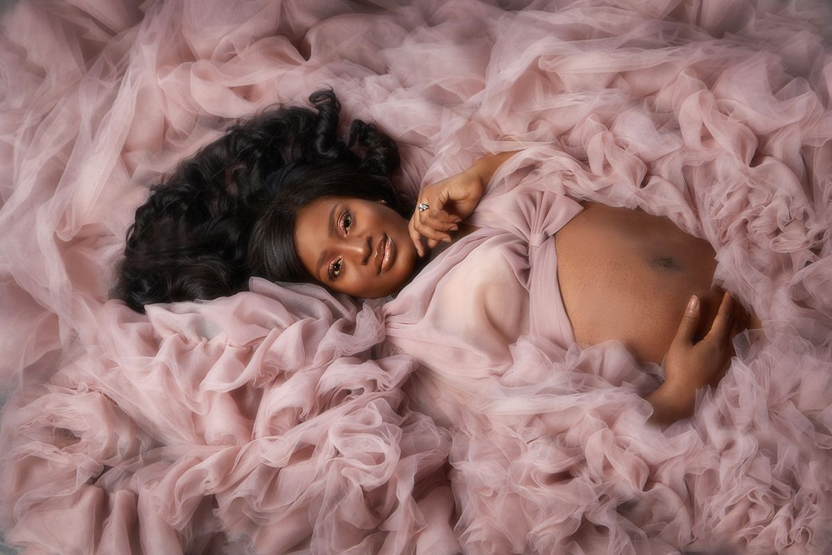 Maternity portrait in a pink fluffy gown — maternity art photography at Oakley Studios, Luton