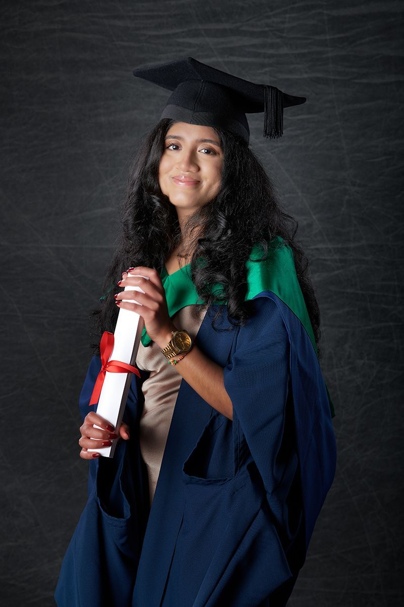 Graduate in cap and gown during a graduation portrait session at Oakley Studios, Luton and Dunstable border