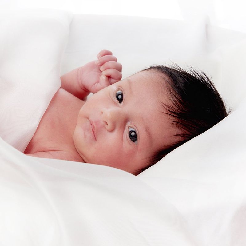 Alert newborn baby during a certified newborn photoshoot at Oakley Studios on the Luton and Dunstable border