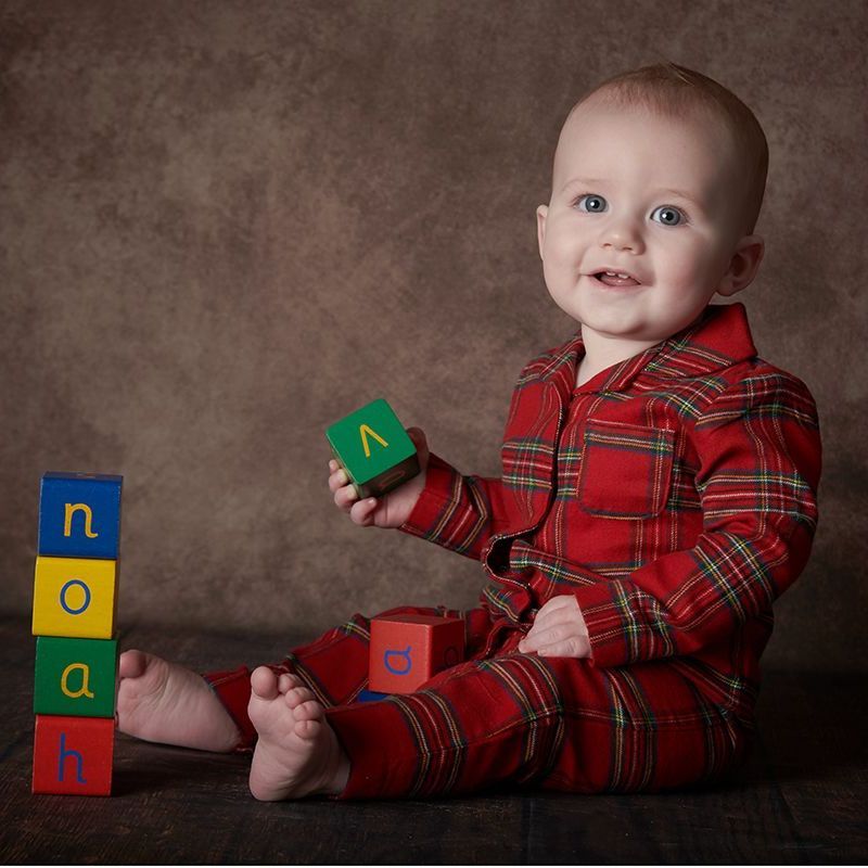 Baby sitting up confidently during a Watch Me Grow 7-11 month photoshoot at Oakley Studios, Bedfordshire