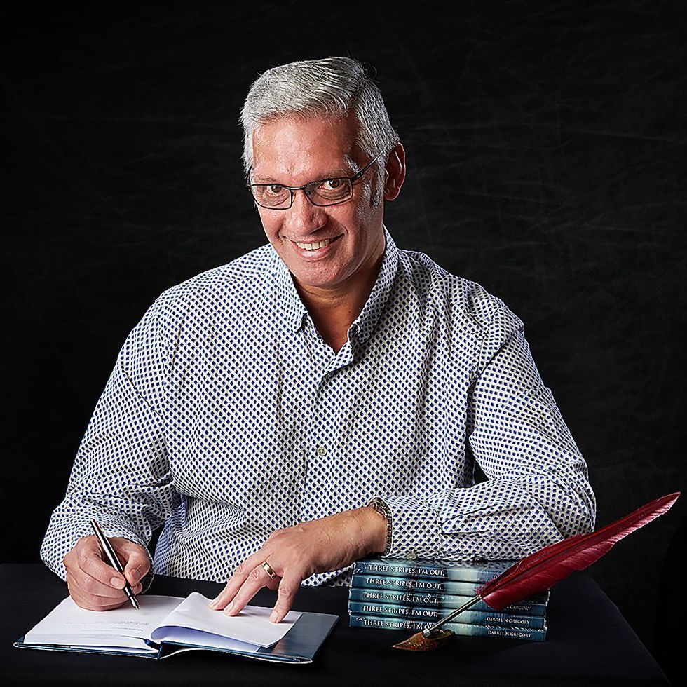 Author Darrell Gregory writing in his notebook — author headshot session at Oakley Studios, Luton and Dunstable border