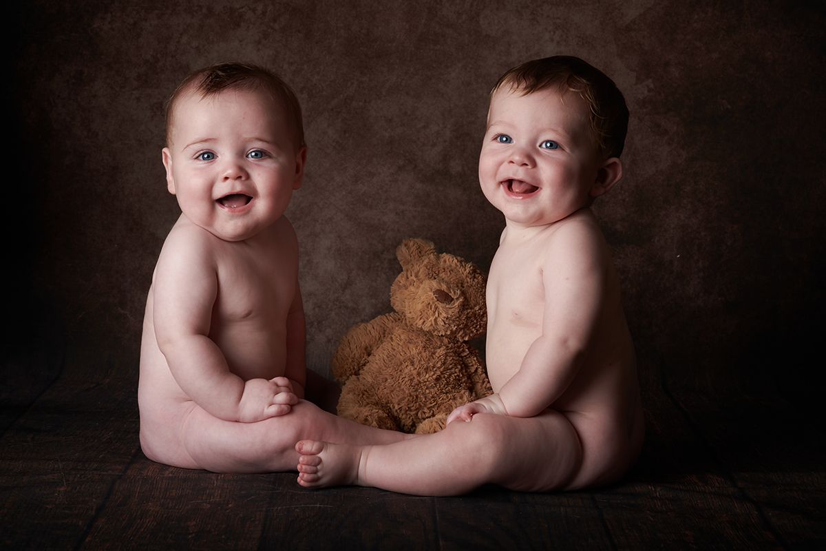 Twin boys with a teddy bear during a children's portrait session at Oakley Studios, Bedfordshire