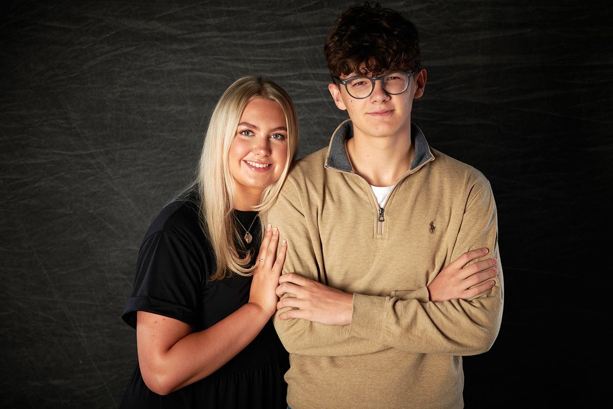 Brother and sister posing for a casual siblings portrait at Oakley Studios, Luton and Bedfordshire