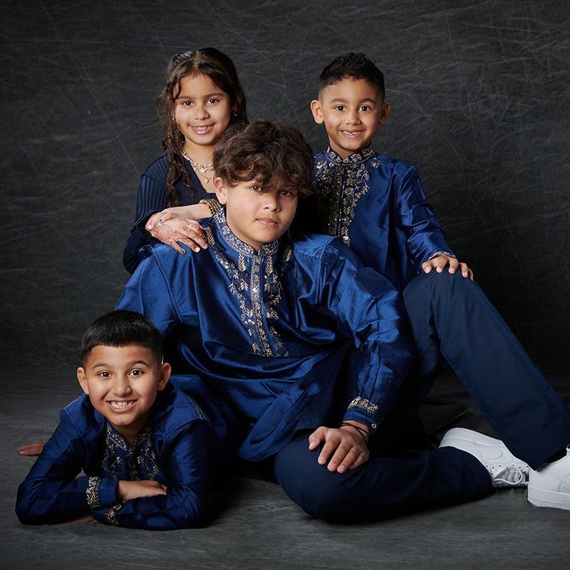 Brothers and sisters in traditional national dress outfits during a children's portrait session at Oakley Studios, Luton and Dunstable border