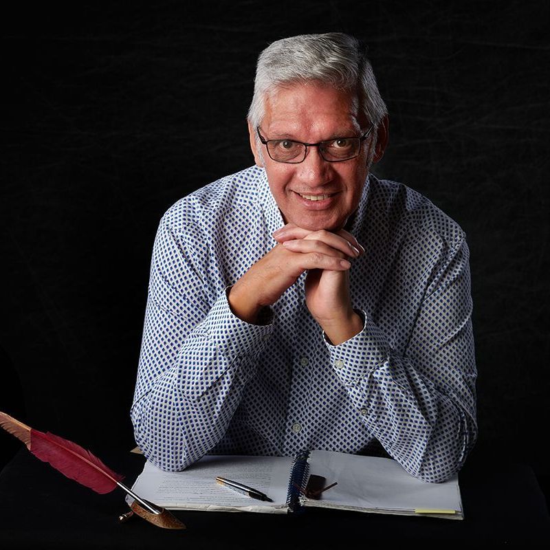 Author Darrell Gregory with his quill pen and manuscript during his author headshot session at Oakley Studios, Luton