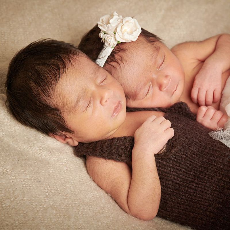 Newborn twins sleeping peacefully during a safe newborn portrait session at Oakley Studios, Luton