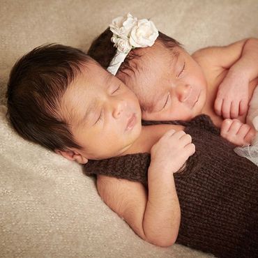 Newborn twins sleeping peacefully during a safe newborn portrait session at Oakley Studios, Luton