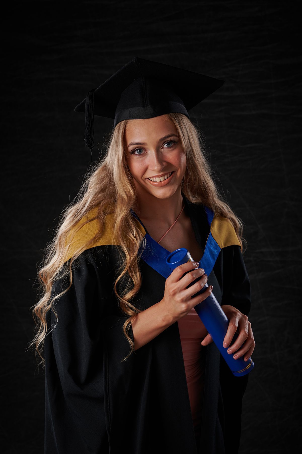 Graduate in cap and gown during a graduation portrait session at Oakley Studios, Luton and Dunstable border