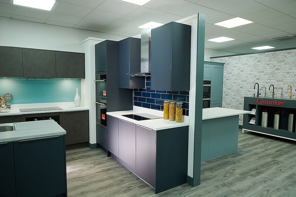 Joe Graham and Sons kitchen showroom display with blue cabinets and white worktops — commercial photography by Oakley Studios, Luton