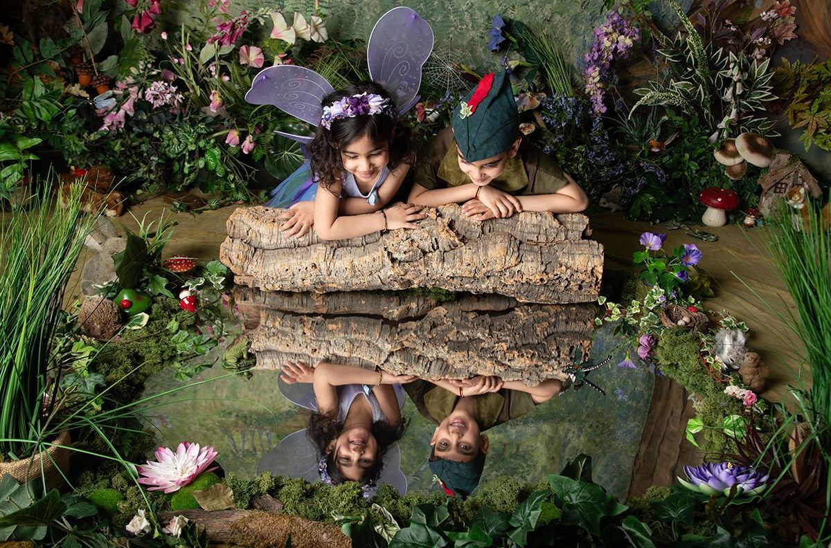 Before — children in fairy costumes on a log, prior to Oakley Studios fairy photoshoot editing and magic effects