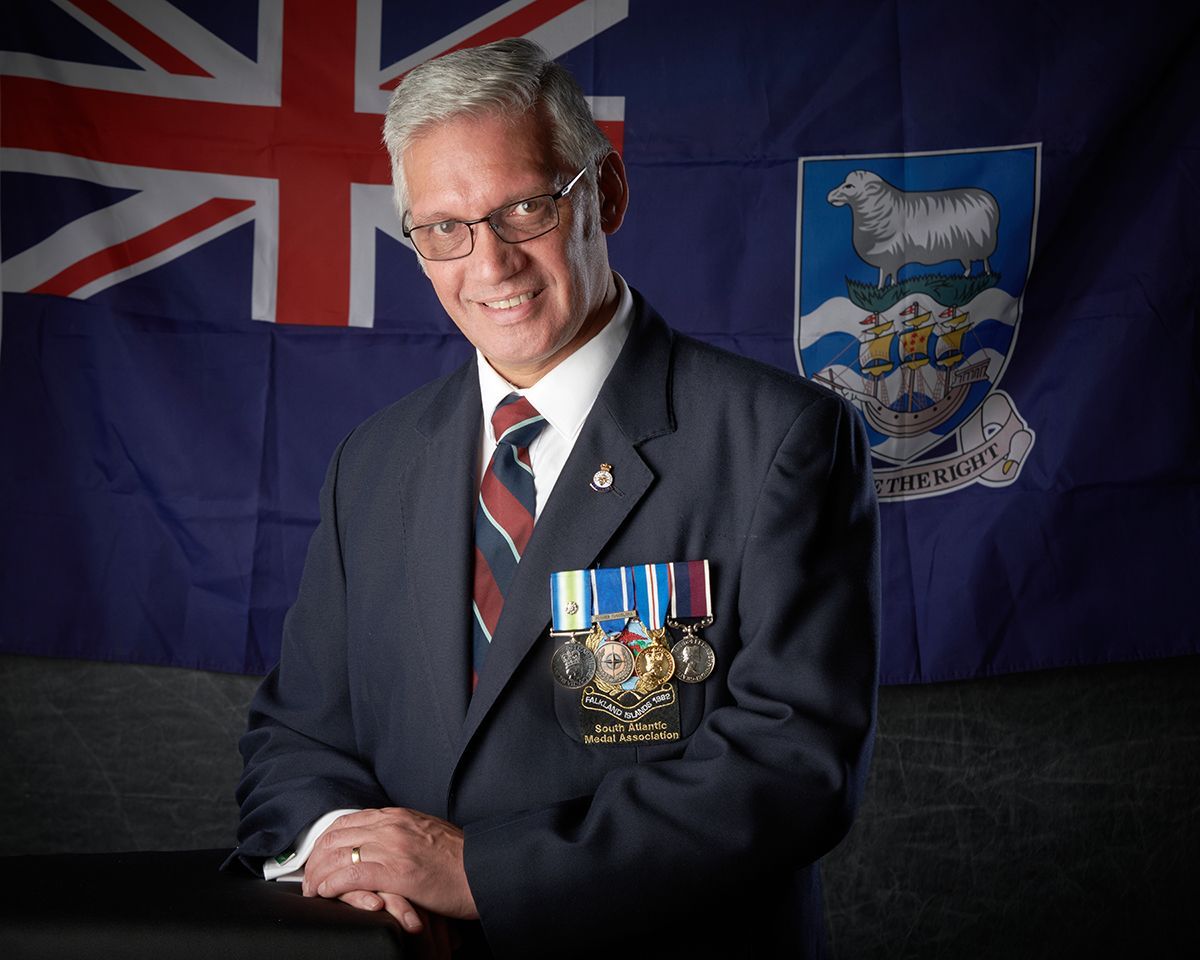 Darrell Gregory smiling with British flag — RAF Falklands veteran author headshot by Oakley Studios, Luton