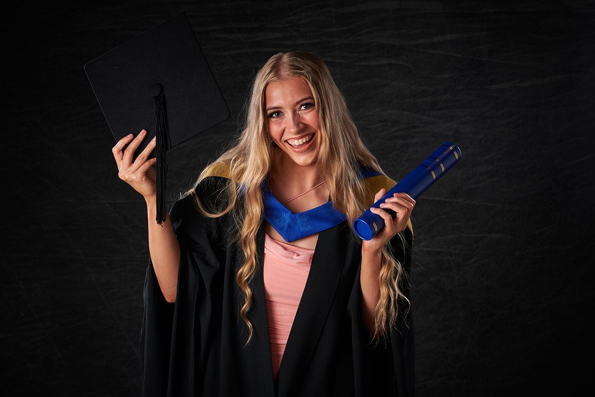 Graduate in cap and gown during a graduation portrait session at Oakley Studios, Luton and Dunstable border