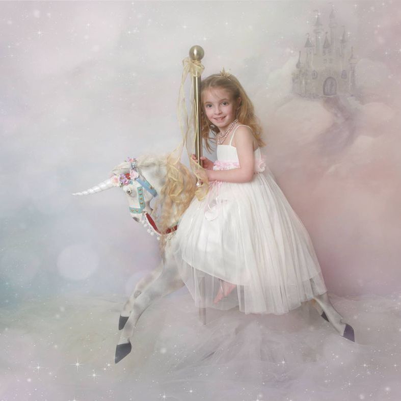 Older child on a unicorn prop during the Mermaids and Unicorns fantasy photoshoot at Oakley Studios, Bedfordshire